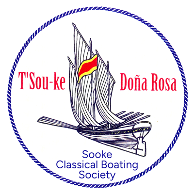 Logo of the Sooke Classical Boating Society. It features a drawing of a traditional sailboat with the text "T'Sou-ke" and "Doña Rosa" above it, encircled by a blue rope outline. The society's name is written below the boat in blue text.